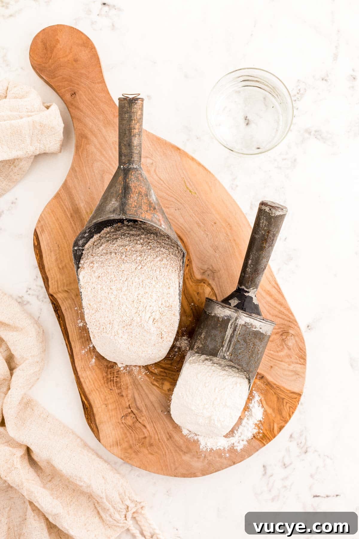 Create a Sourdough Starter at Home: Step-by-Step Guide 4 Ingredients to make sourdough starter on a wooden serving board.