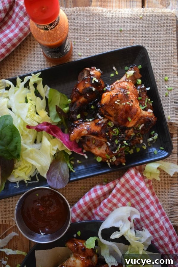 Overhead view of the sticky honey garlic wings with dipping sauce and a napkin