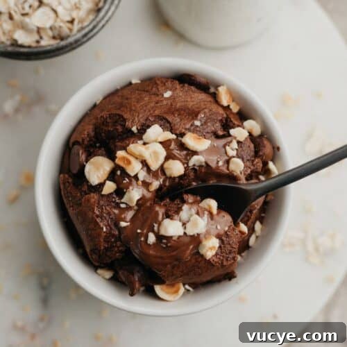 An overhead shot of a small circular dish with Nutella baked oats.