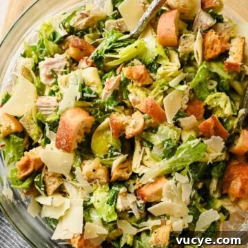 Creamy Caesar Pasta Salad with Crispy Croutons and Parmesan 15 tortellini pasta salad with caesar dressing tossed in glass bowl.