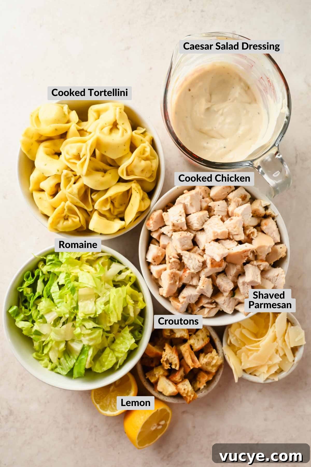 Creamy Caesar Pasta Salad with Crispy Croutons and Parmesan 3 labeled ingredients for tortellini pasta salad with caesar dressing in individual bowls.