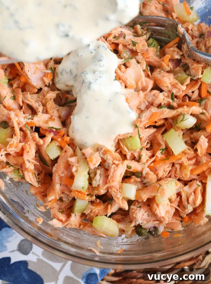 Salmon Salad with Dill & Capers: Fresh Summer Recipe 6 Dressing added to salmon salad in bowl