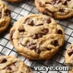 Brown Butter Chocolate Chip Cookies topped with flaked sea salt on a wire cooling rack