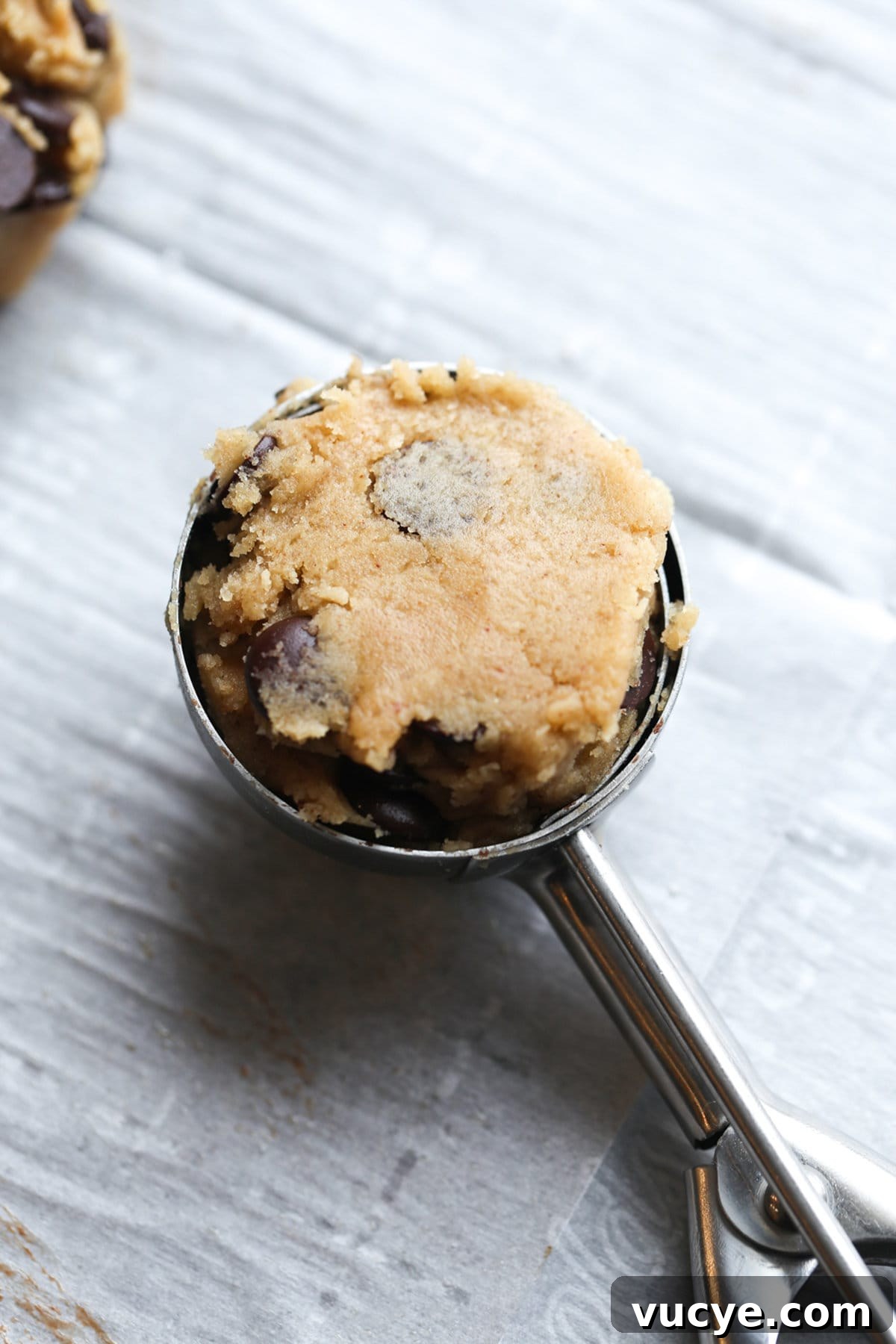 A scoop of cookie dough in a medium cookie scoop