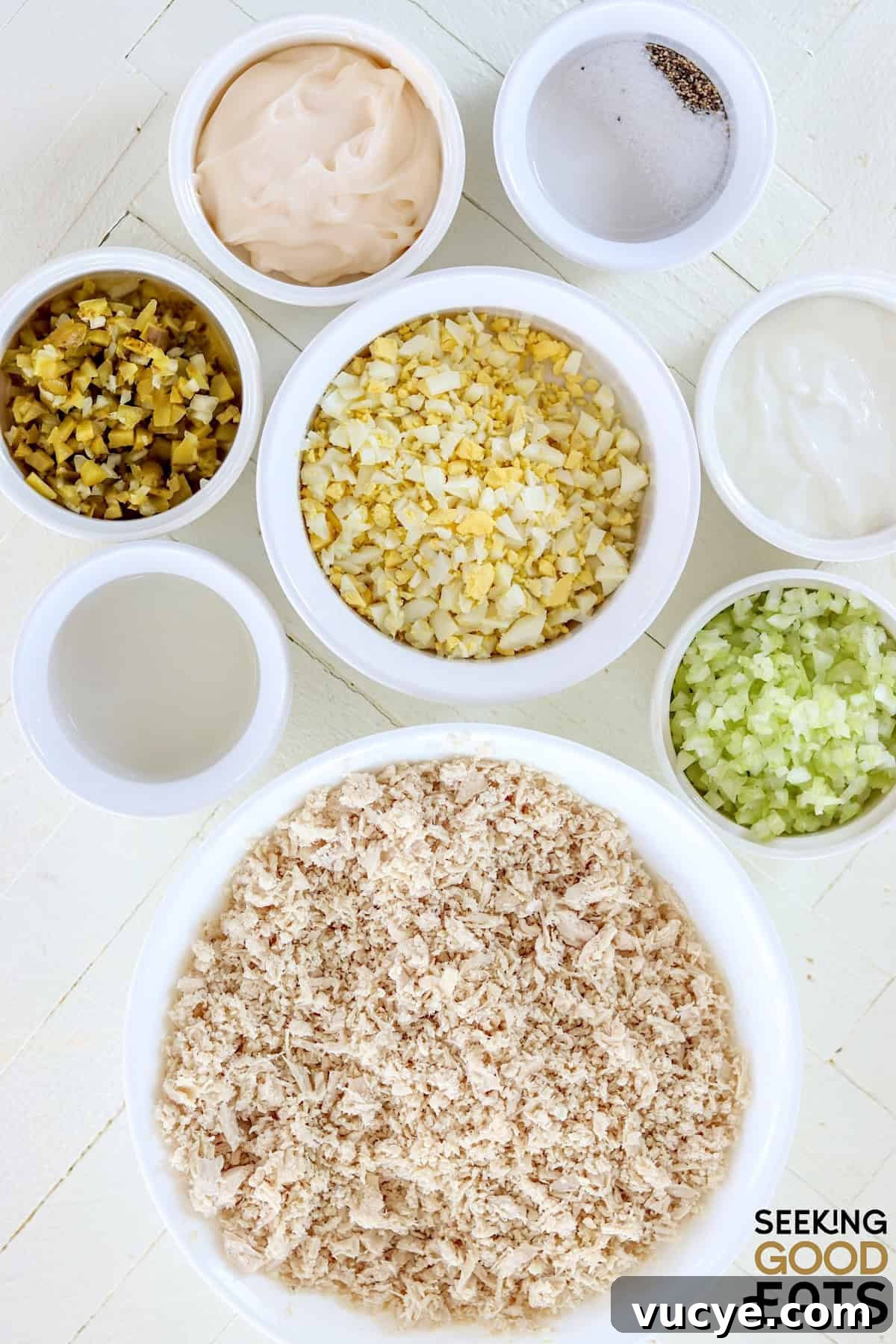 Ingredients needed for making chick fil a chicken salad on a white board.
