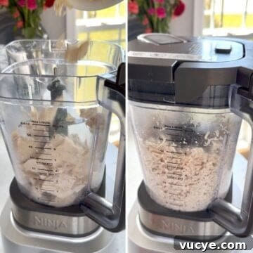 Processing the cooked chicken in a blender to shred it finely for the chicken salad.