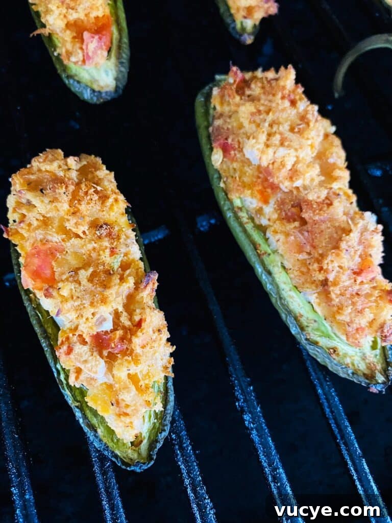 Stuffed jalapenos on the smoker before cooking