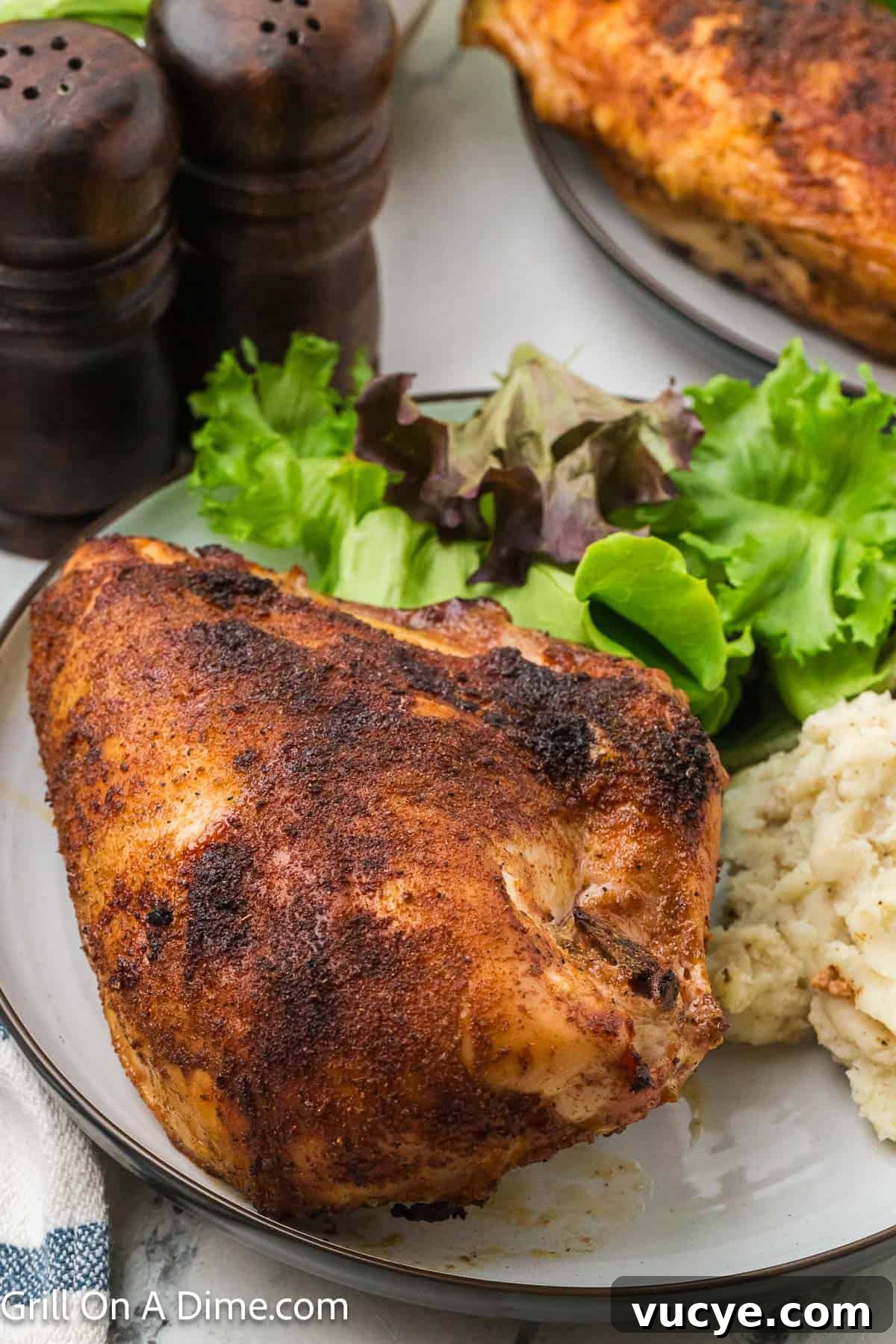 Smoked Bone-In Chicken Breasts Recipe for Juicy, Flavorful Meat 12 Smoked chicken breast on a plate with a side of green salad and mashed potatoes