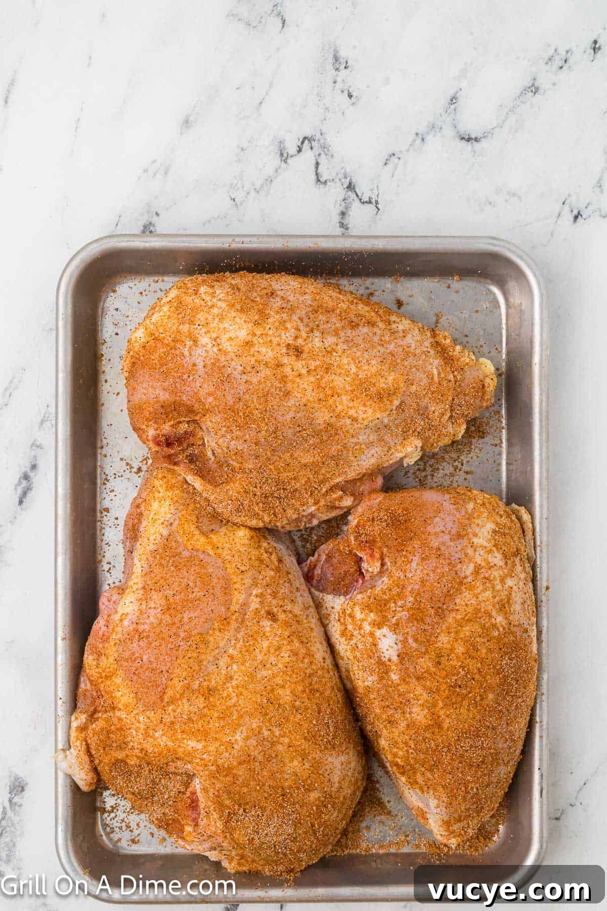 Smoked Bone-In Chicken Breasts Recipe for Juicy, Flavorful Meat 6 Seasoned chicken breast on a baking sheet
