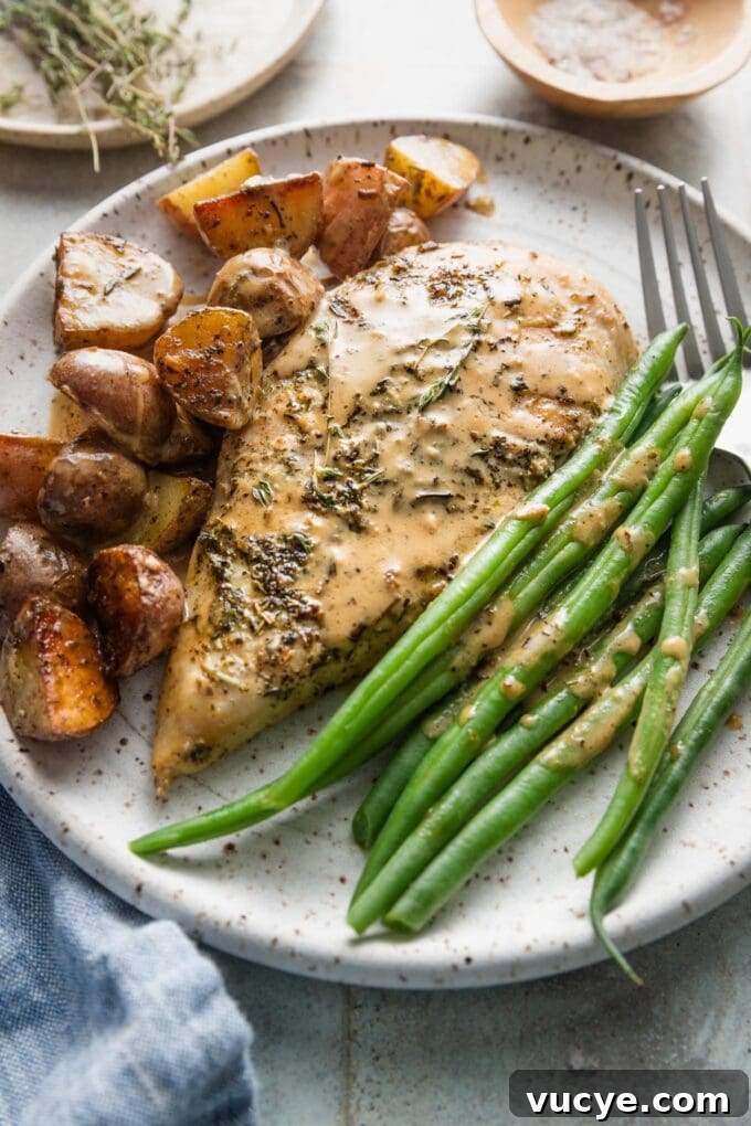 Creamy Dijon Chicken with Roasted Potatoes Recipe 2 Dinner plate of creamy Dijon chicken, skillet-fried potatoes, and green beans, all dressed with a light Dijon cream sauce.