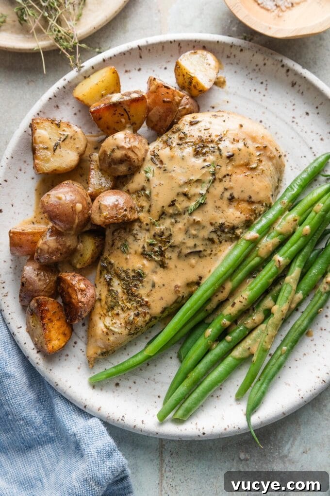 Creamy Dijon Chicken with Roasted Potatoes Recipe 11 Plated Dijon chicken and potatoes served with green beans and extra drizzled Dijon cream sauce.