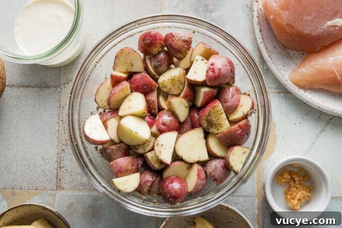Creamy Dijon Chicken with Roasted Potatoes Recipe 5 Glass prep bowl filled with quartered baby red potatoes.