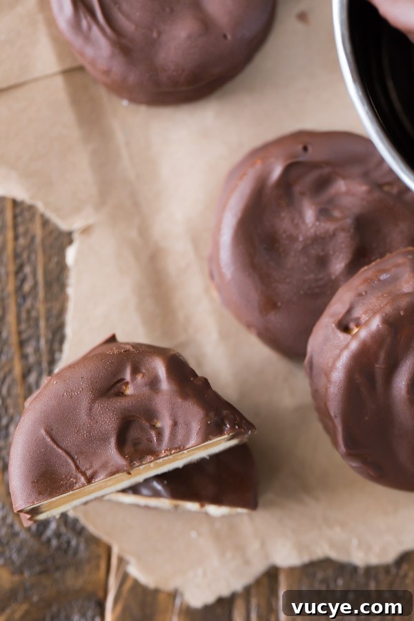 Peanut Butter Buckeye Cookie Recipe: Chocolate Peanut Butter Balls 2 Peanut Butter Buckeye Cookie cut in half and stacked, with more whole cookies around it.
