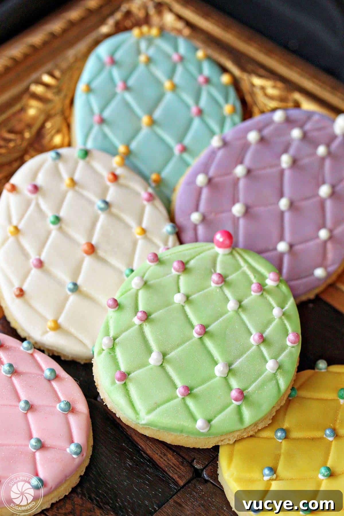 Bring a little sparkle to your Easter desserts with these gorgeous Easter Egg Sugar Cookies! Everyone loves decorating these Easter cookies, and they make great gifts or Easter basket goodies! Easter Egg Sugar Cookies with colorful sugar pearl accents on a gold tray