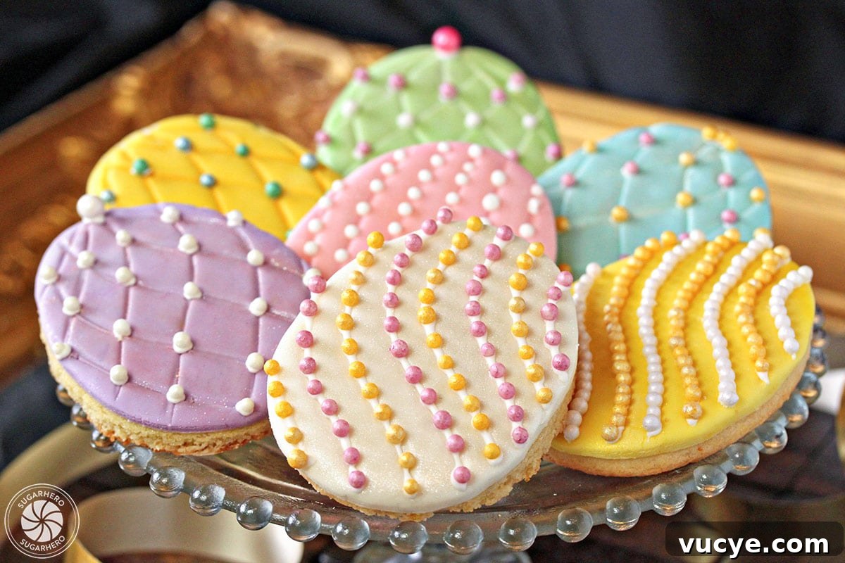 Bring a little sparkle to your Easter desserts with these gorgeous Easter Egg Sugar Cookies! Everyone loves decorating these Easter cookies, and they make great gifts or Easter basket goodies! Easter egg sugar cookies on a gold tray with colorful sugar pearls