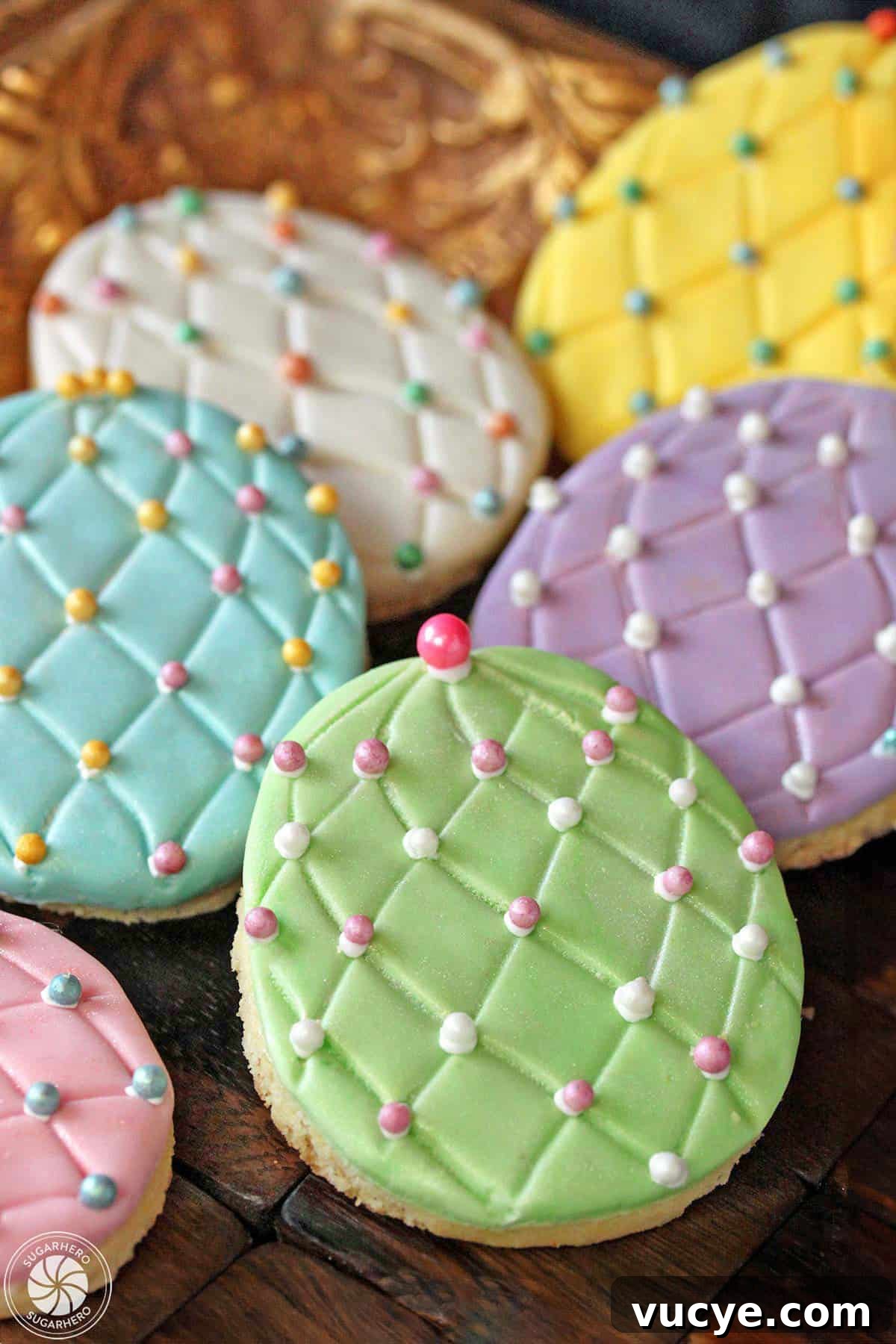 Bring a little sparkle to your Easter desserts with these gorgeous Easter Egg Sugar Cookies! Everyone loves decorating these Easter cookies, and they make great gifts or Easter basket goodies! Three Easter egg sugar cookies on a gold tray