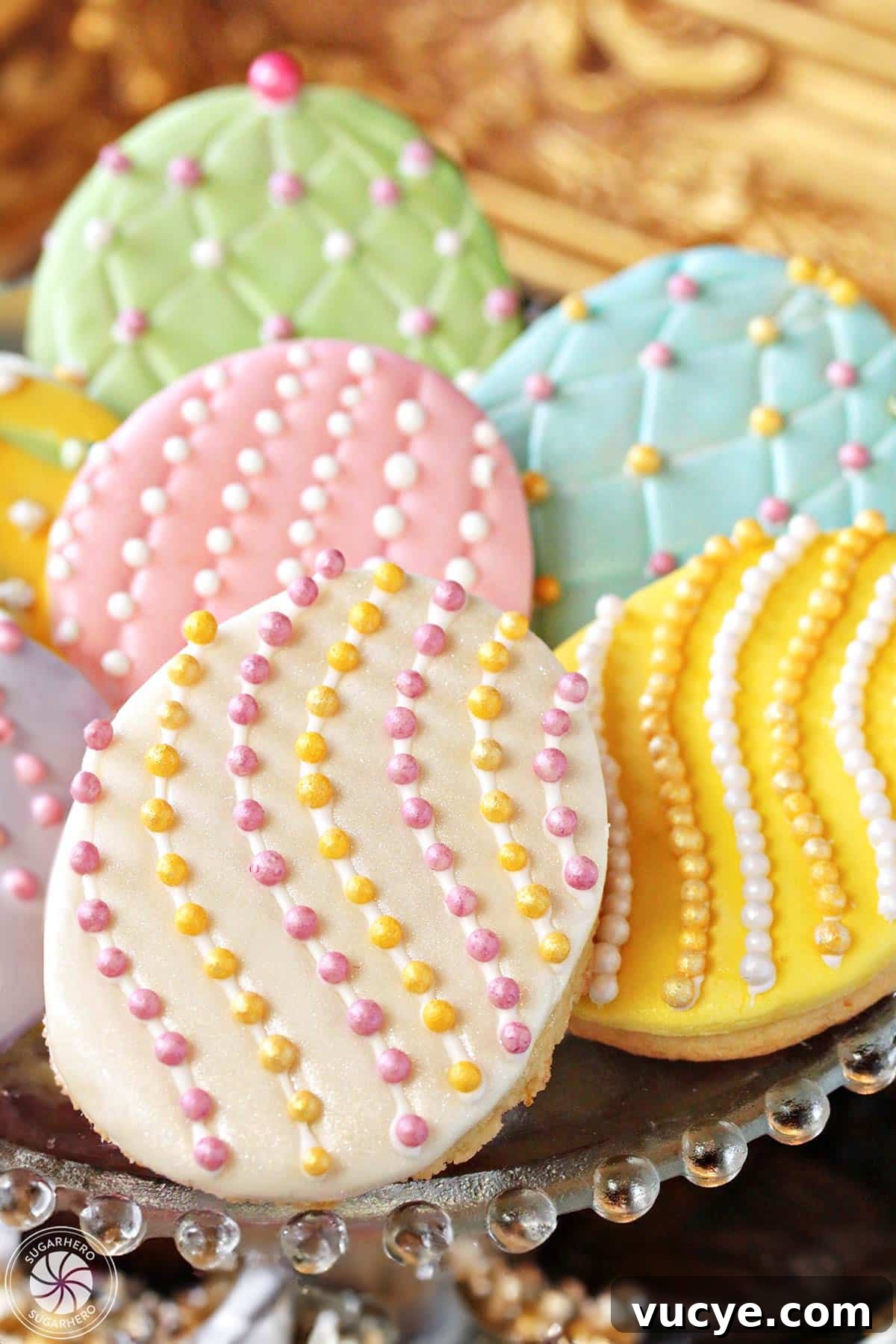 Bring a little sparkle to your Easter desserts with these gorgeous Easter Egg Sugar Cookies! Everyone loves decorating these Easter cookies, and they make great gifts or Easter basket goodies! Stack of Easter egg sugar cookies with colorful sugar pearls and fondant decorations