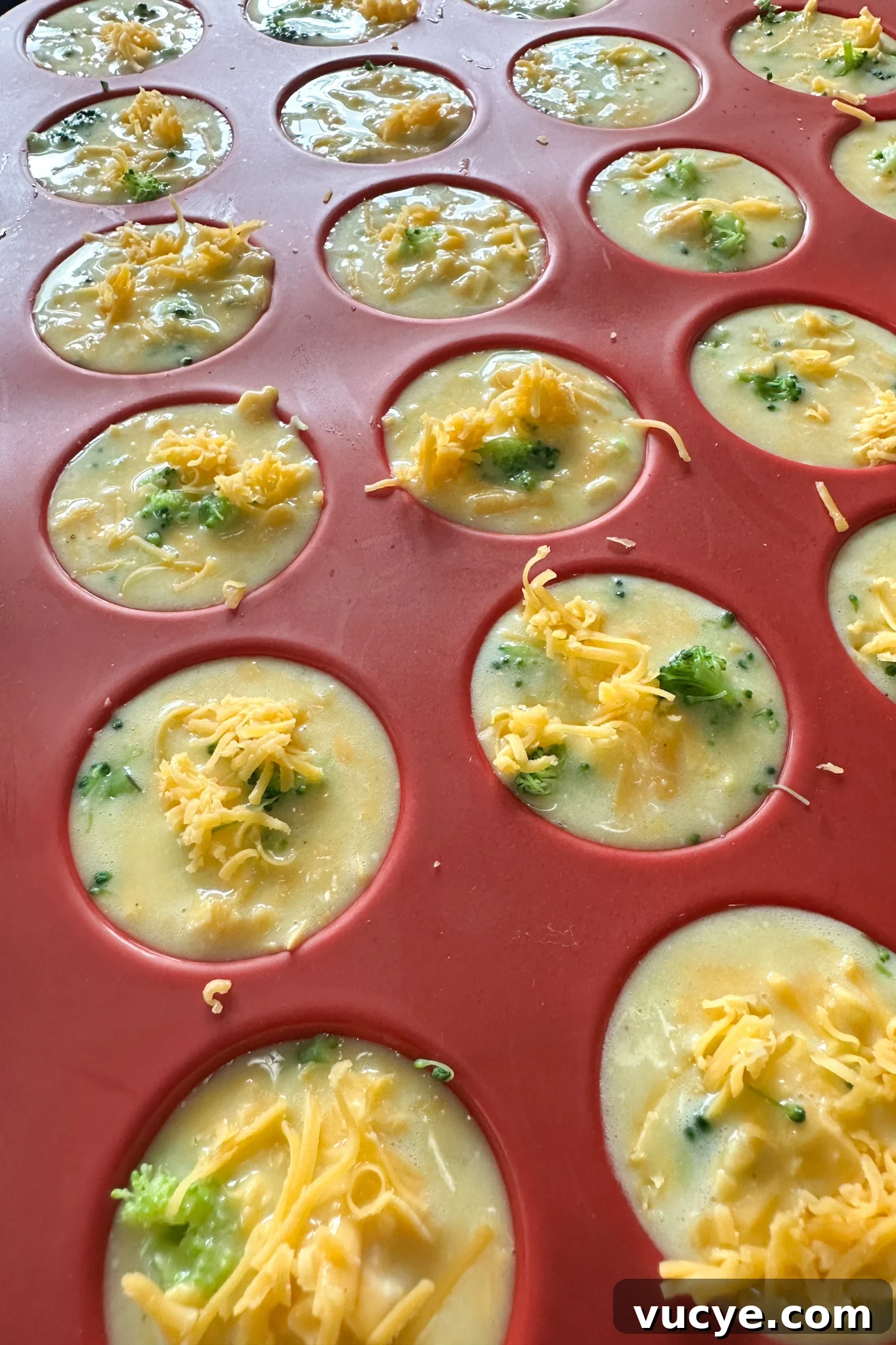 Broccoli egg bites ready to bake.