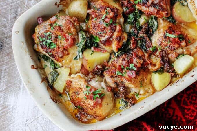 Tuscan chicken and potatoes in casserole dish, horizontal shot
