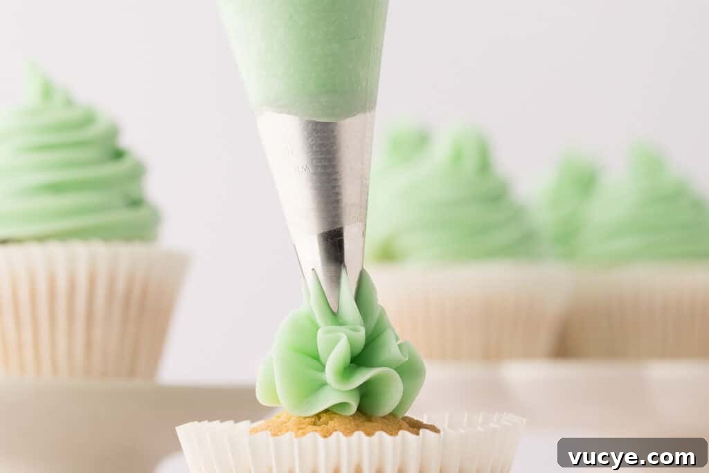 Silky Swiss Meringue Buttercream Recipe for Perfect Frosting 15 swiss meringue buttercream being piped from a bag