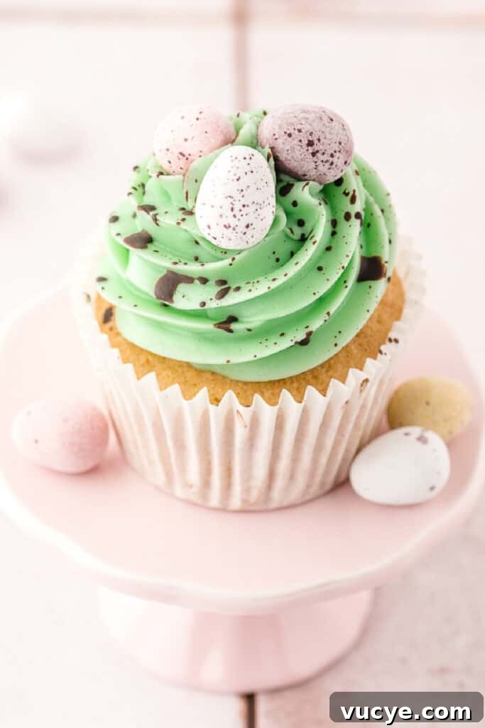Silky Swiss Meringue Buttercream Recipe for Perfect Frosting 3 green swiss buttercream piped on top of a vanilla cupcake