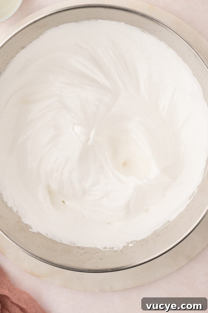 Silky Swiss Meringue Buttercream Recipe for Perfect Frosting 7 Add the bowl to the stand mixer fitted with the whisk attachment. Whisk on a medium-high speed until the egg whites reach stiff peaks. This will take at least 10 minutes but sometimes longer.
