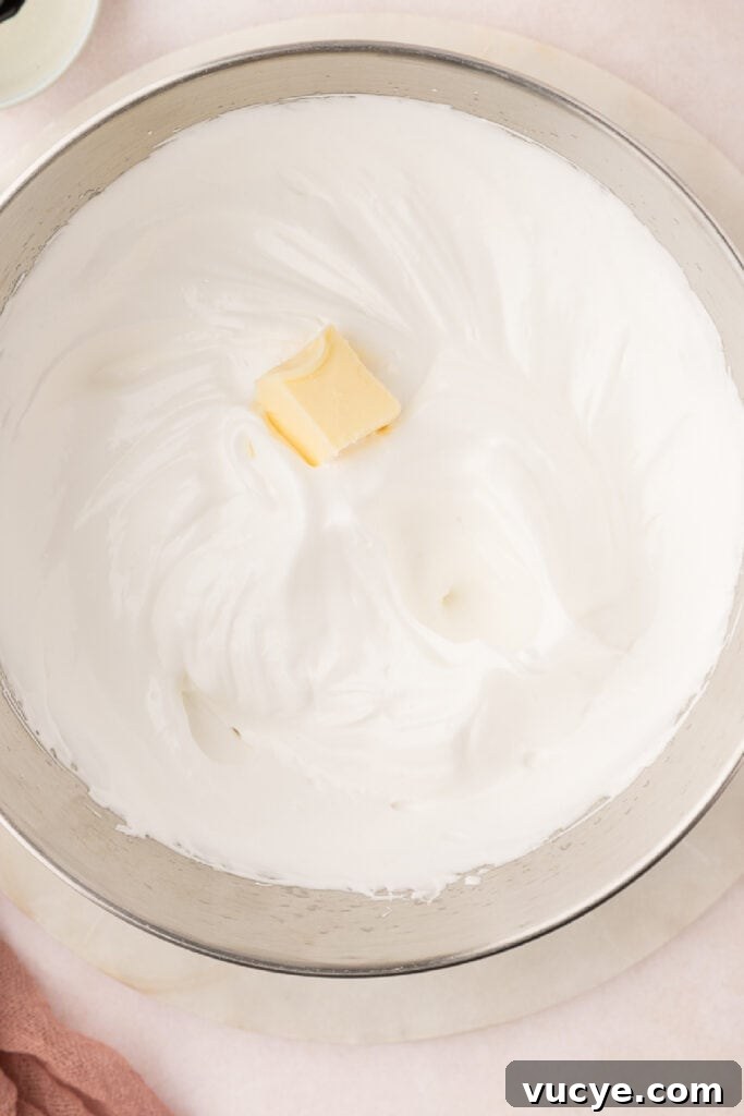 Silky Swiss Meringue Buttercream Recipe for Perfect Frosting 9 When the outside of the bowl is cool, add the butter a tablespoon at a time. Beat at high speed, fully incorporating each addition of butter until all the butter has been added.