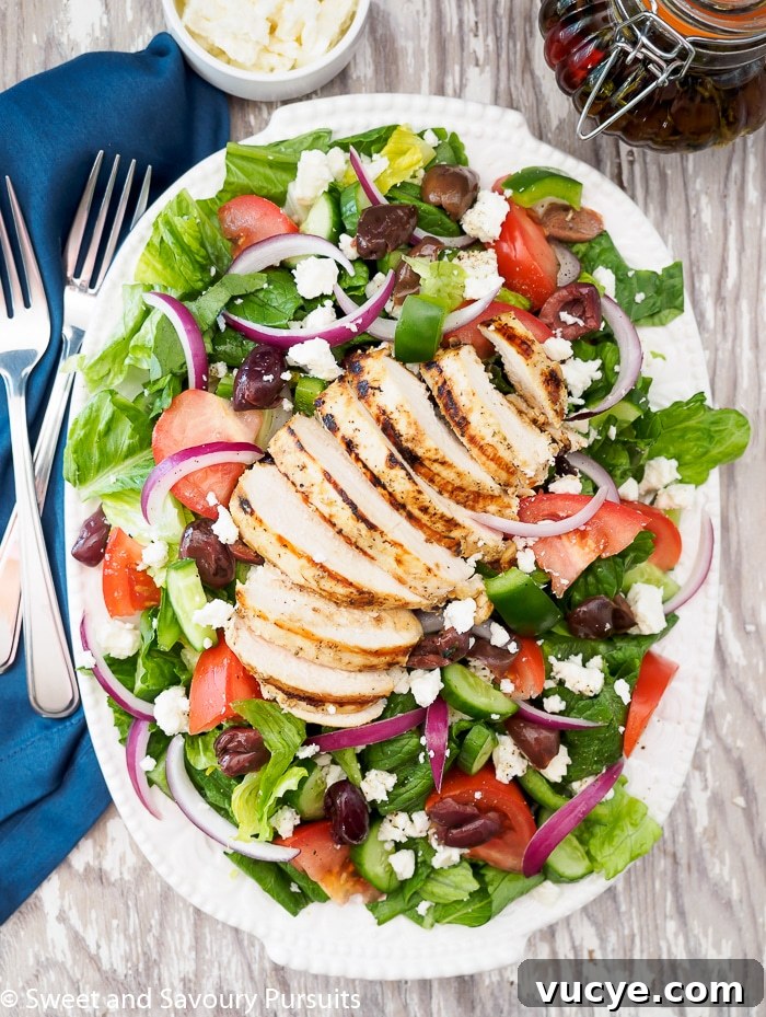 Greek Salad with Grilled Chicken served on platter.