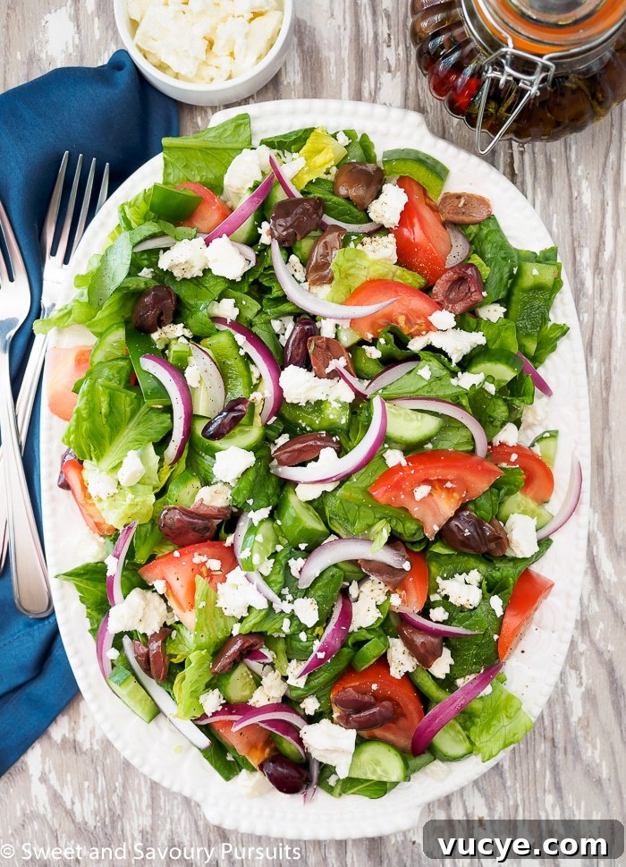 Greek style salad served on large white oval plate.