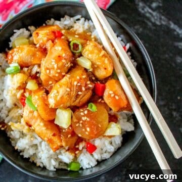 Sweet and sour shrimp in black bowl.