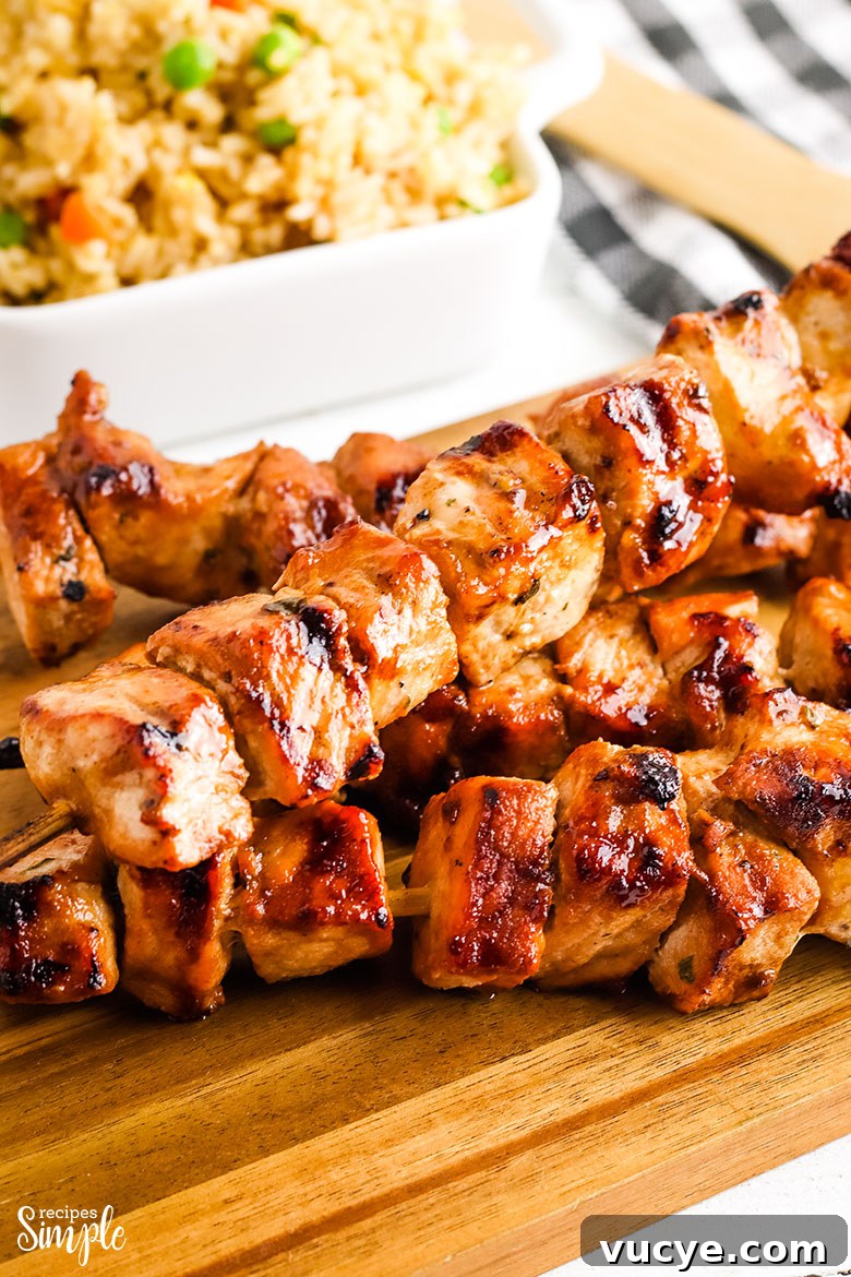 Grilled Asian Pork Kabobs on wooden serving block