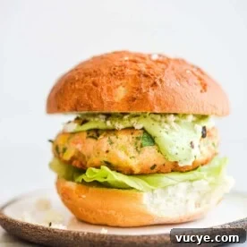 Maple Teriyaki Salmon Rice Bowls with Sesame & Scallions 8 a salmon burger on a bun with lettuce and green goddess dressing
