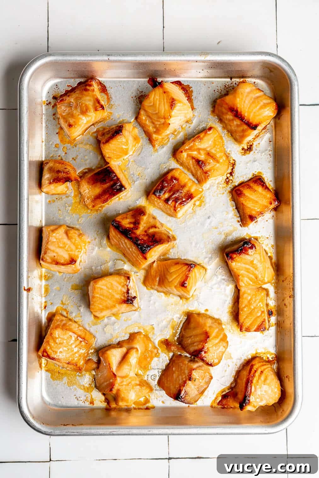 221207_Teriyaki Salmon Bowls-12 Cooked, cubed teriyaki salmon on a sheet pan.