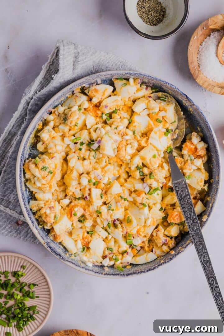Ingredients for cottage cheese egg salad in a mixing bowl, mixed