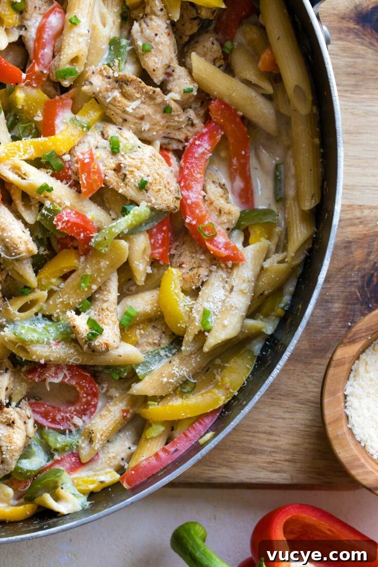Skillet of creamy Rasta pasta with parmesan and bell pepper.
