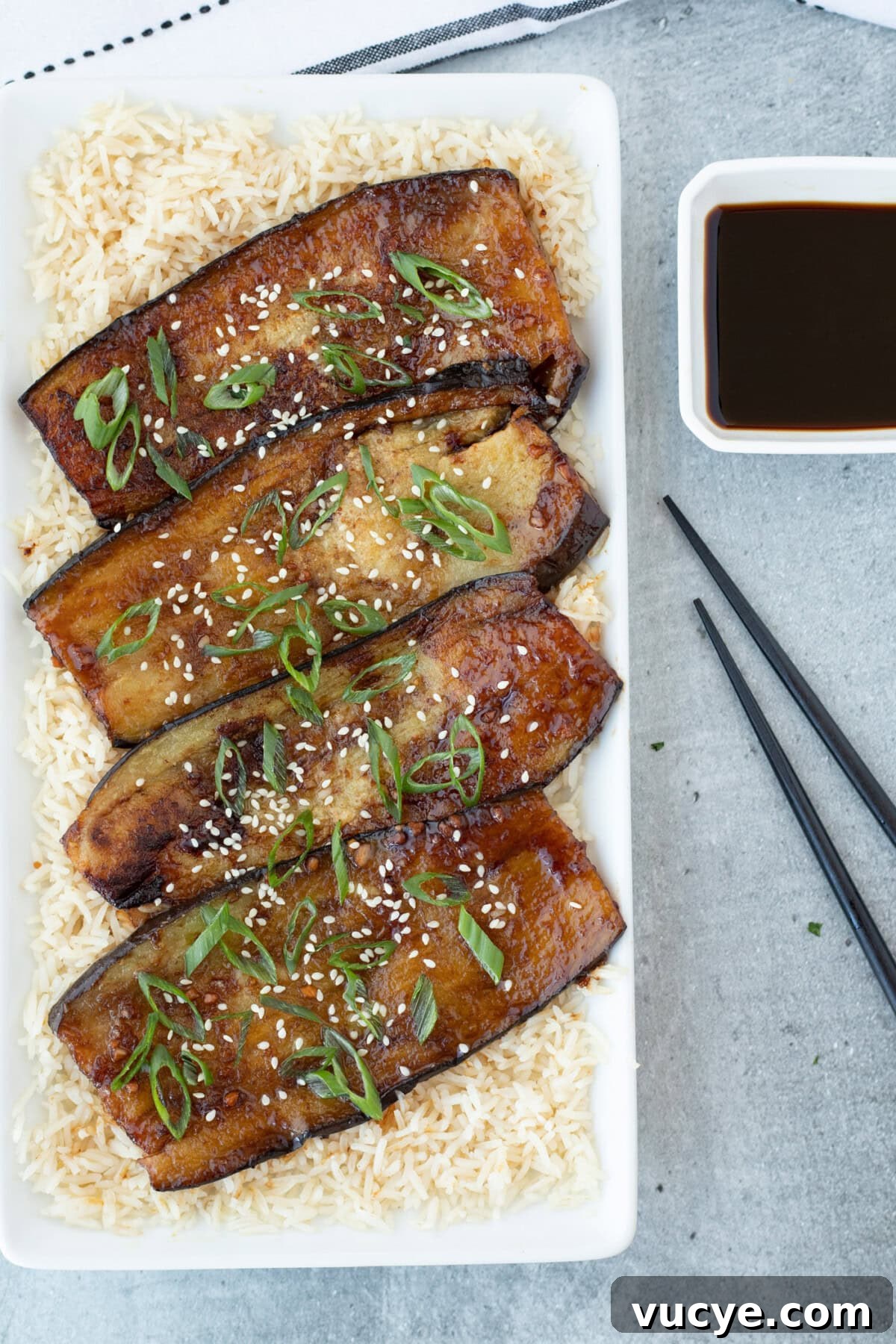 Soy-Glazed Eggplant Recipe: Savory Stir-Fried Japanese Aubergine 2 Soy Glazed Eggplant with chopsticks