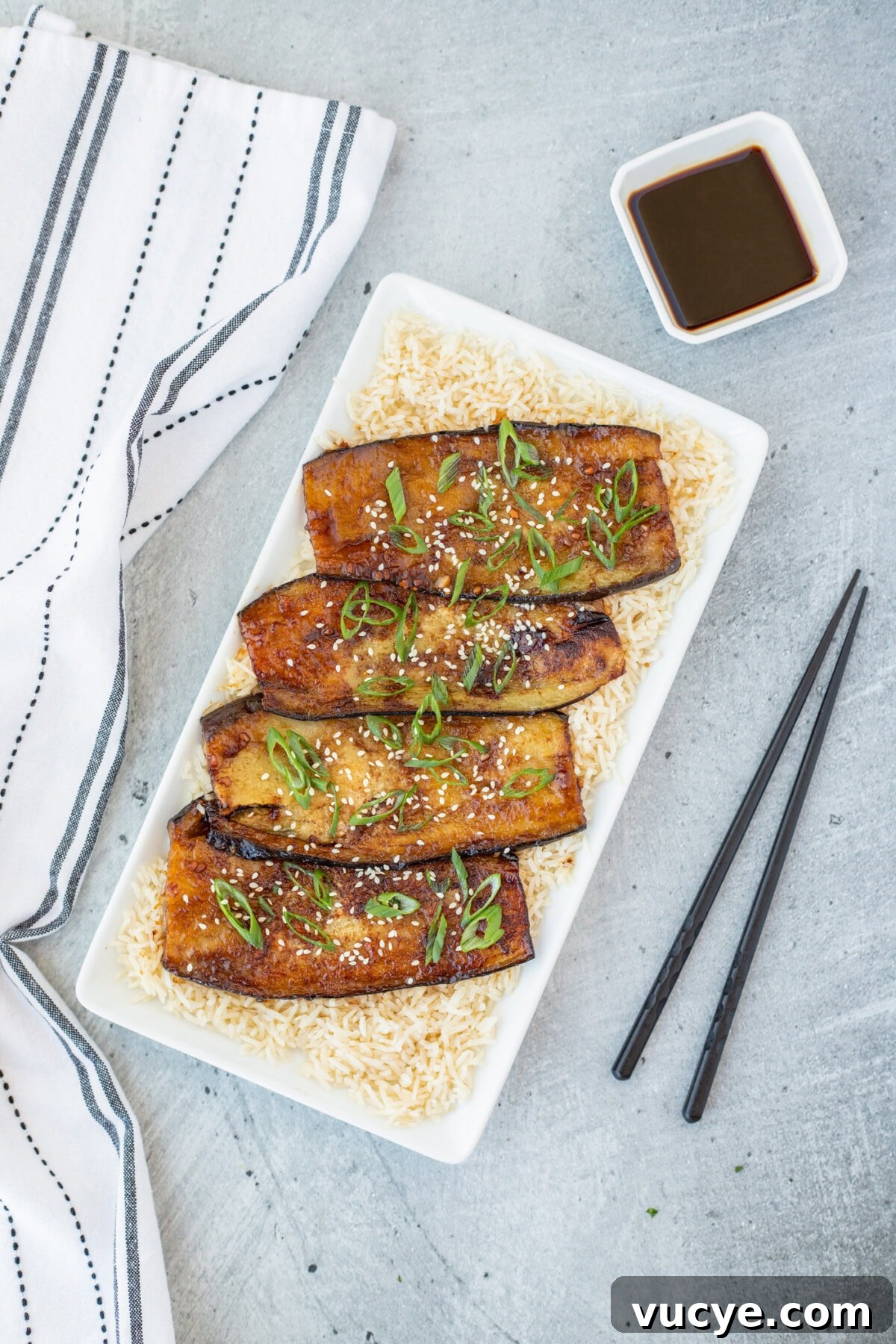 Soy-Glazed Eggplant Recipe: Savory Stir-Fried Japanese Aubergine 8 Soy Glazed Eggplant over rice on a plattter