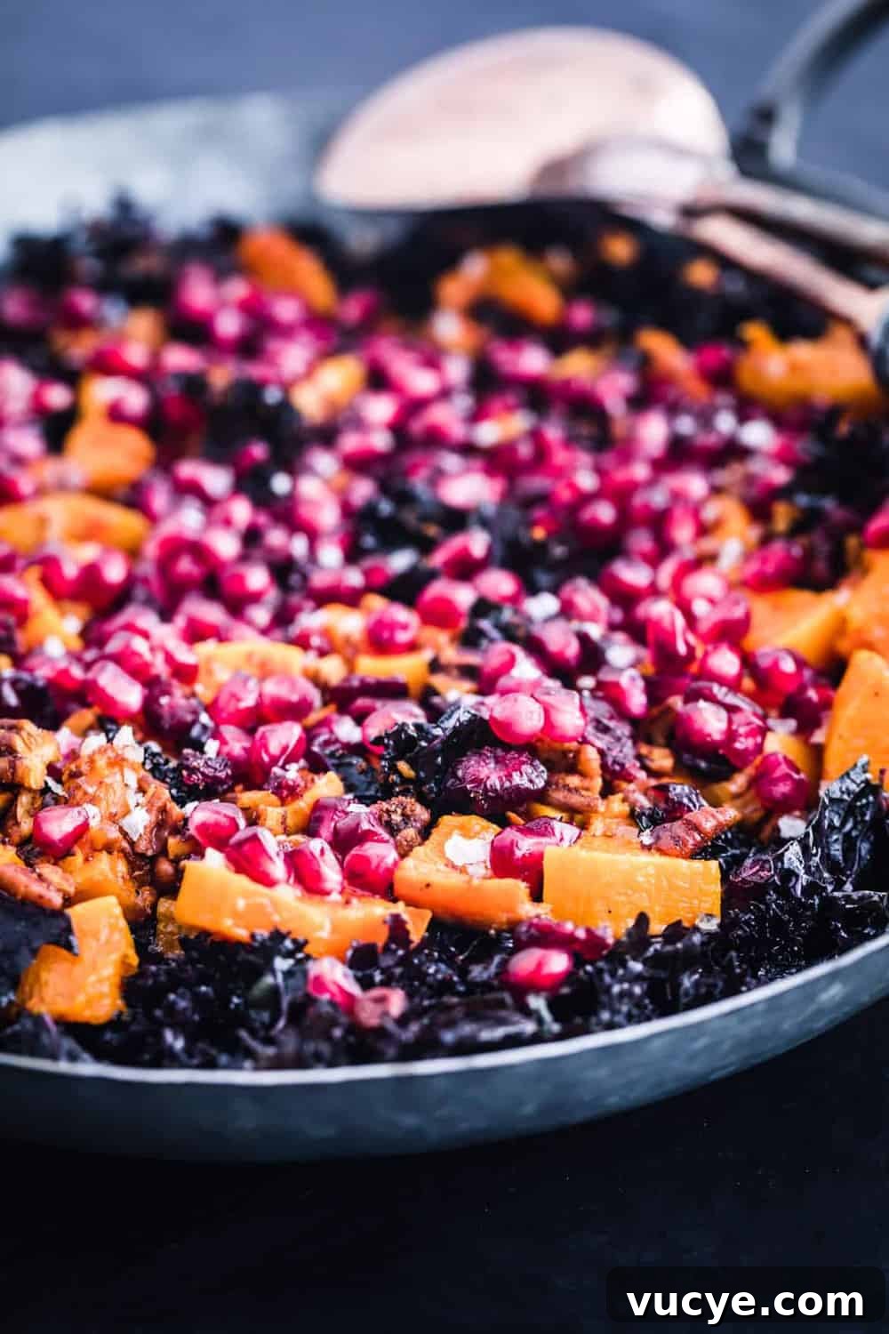 The final salad with kale, squash, spiced pecans, dried cranberries and pomegranate seeds.