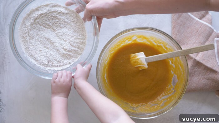 toddler hands helping mom make pumpkin muffins