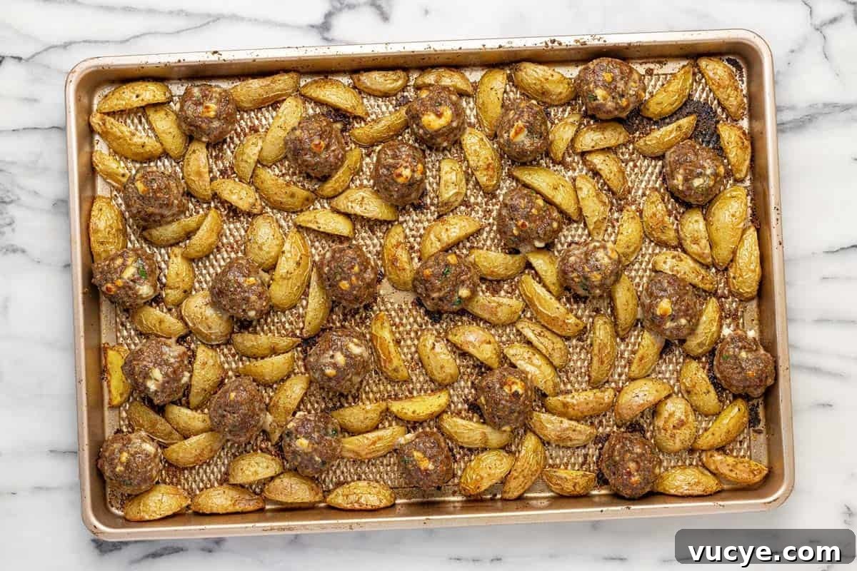 Greek-Style Sheet Pan Meatballs with Roasted Potatoes 7 Sheet pan with roasted potatoes and Greek meatballs.