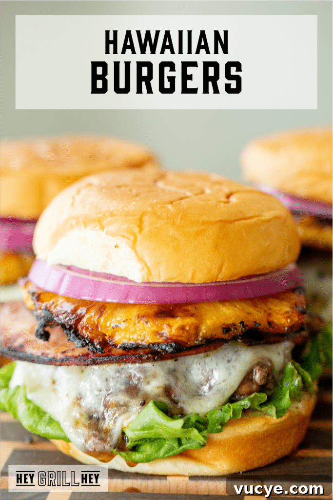Hawaiian Teriyaki Burger Recipe with Pineapple and Garlic Soy Glaze 2 Three Hawaiian burgers on a wooden serving platter with text overlay - Hawaiian Burger.