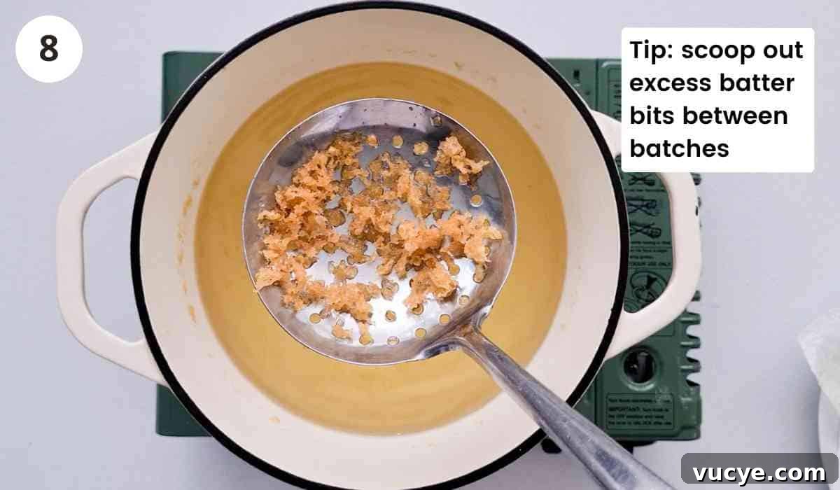 crispy batter on a slotted spoon with caption