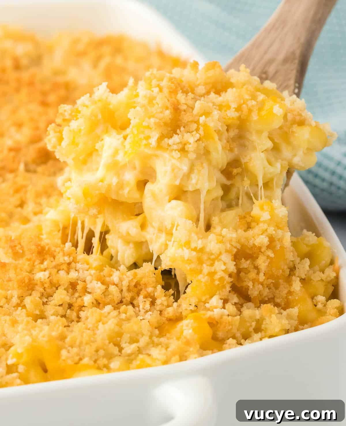 Creamy Baked Macaroni and Cheese Casserole Recipe 2 scooping mac and cheese from the baking dish