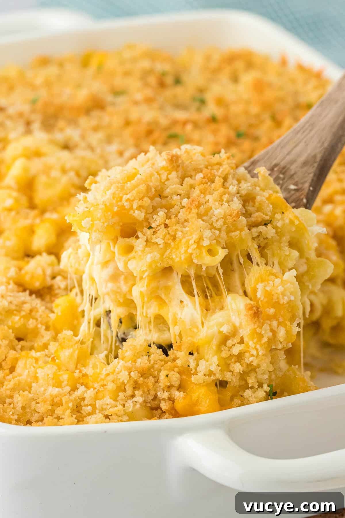 Creamy Baked Macaroni and Cheese Casserole Recipe 3 scooping mac and cheese from the baking dish