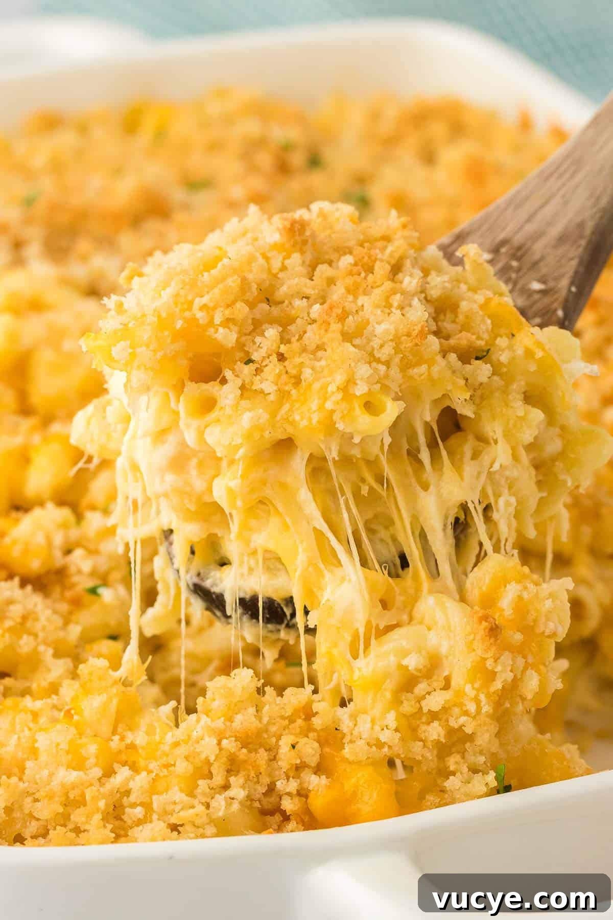 Creamy Baked Macaroni and Cheese Casserole Recipe 21 scooping mac and cheese from the baking dish