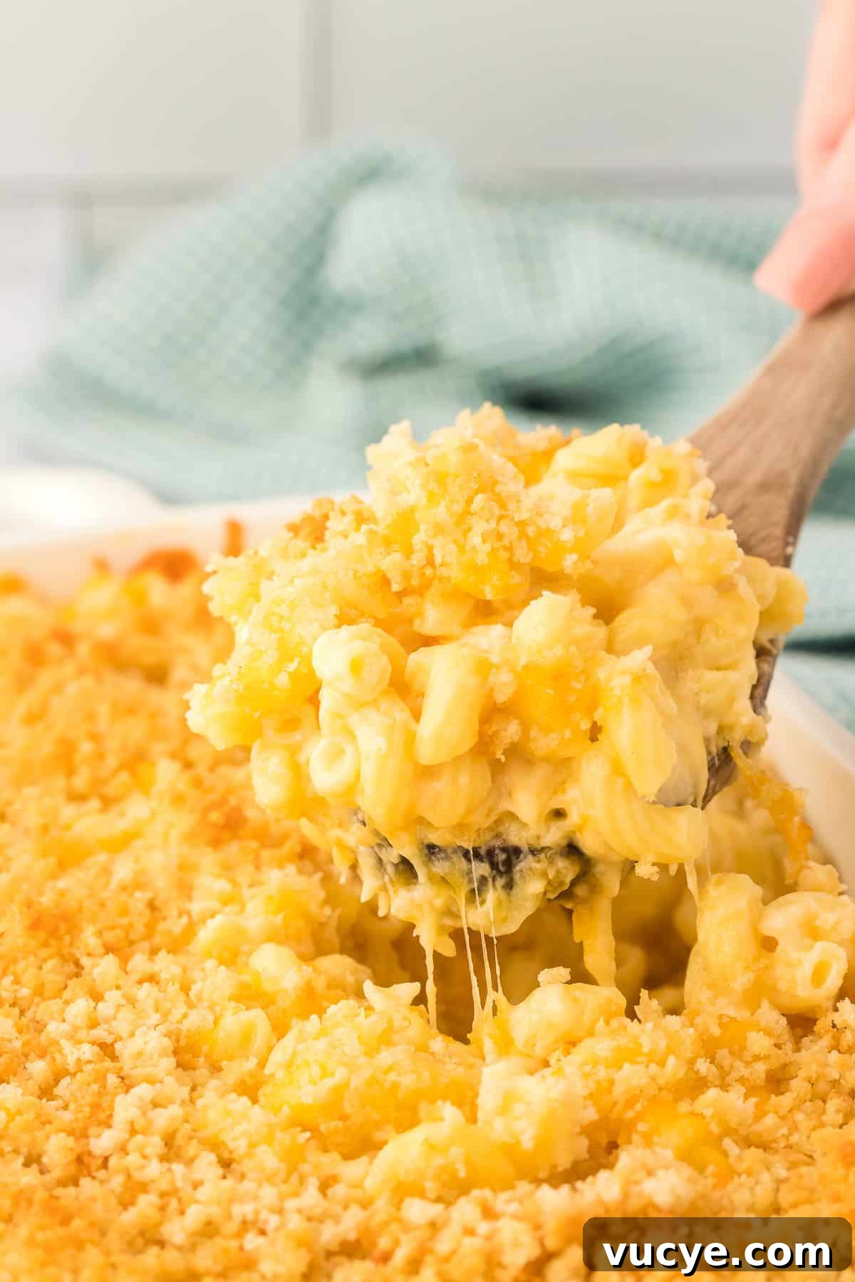 Creamy Baked Macaroni and Cheese Casserole Recipe 22 scooping mac and cheese from the baking dish