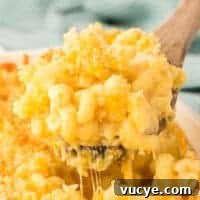Creamy Baked Macaroni and Cheese Casserole Recipe 23 scooping mac and cheese from the baking dish