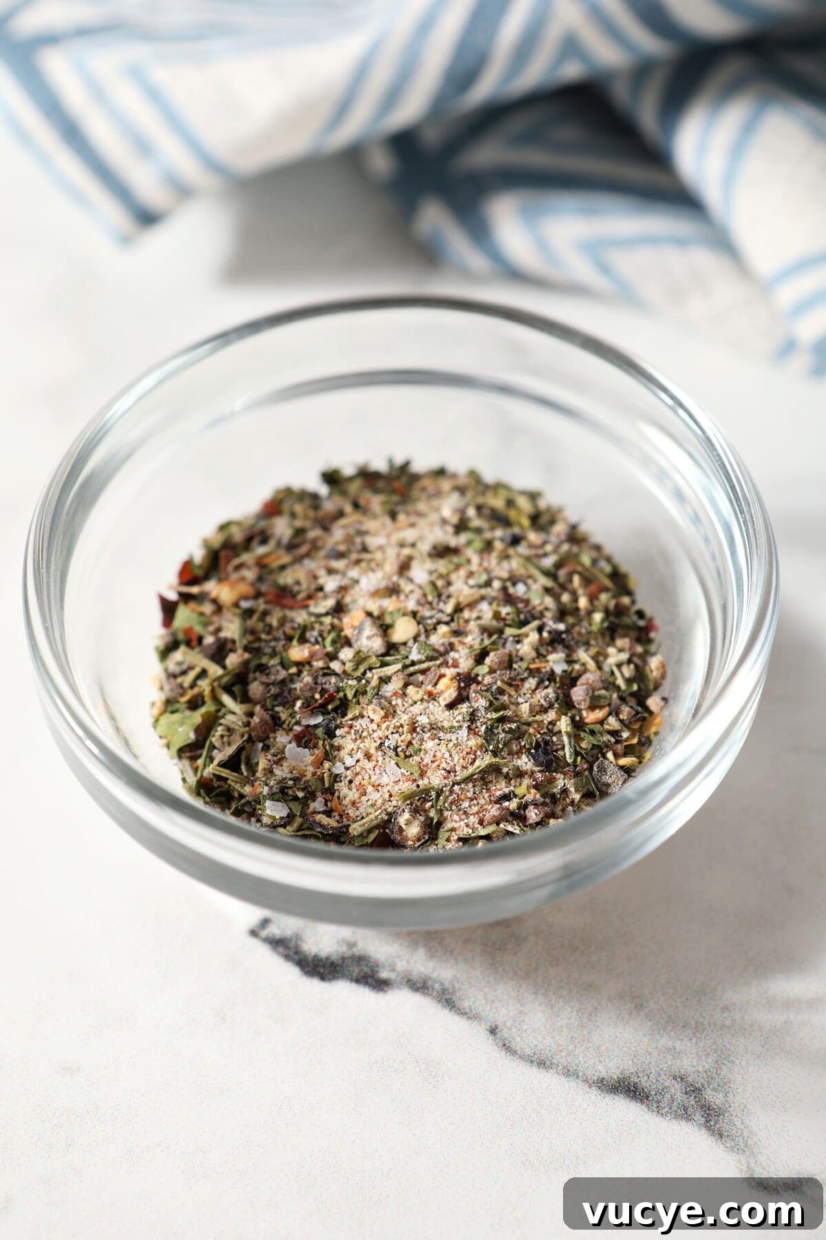 A small batch steak seasoning blend in a glass bowl on marble