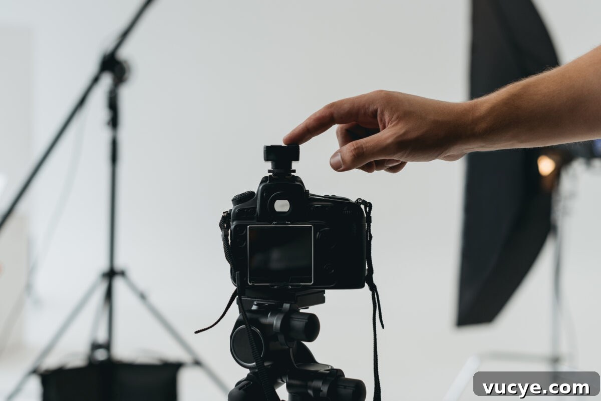 A hand about to press the capture button on a camera 