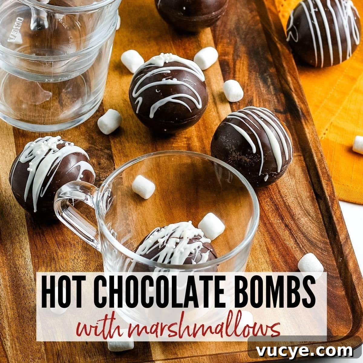 DIY Hot Chocolate Bombs Filled with Mini Marshmallows 2 close up of hot chocolate bombs on a tray and in a glass with text overlay